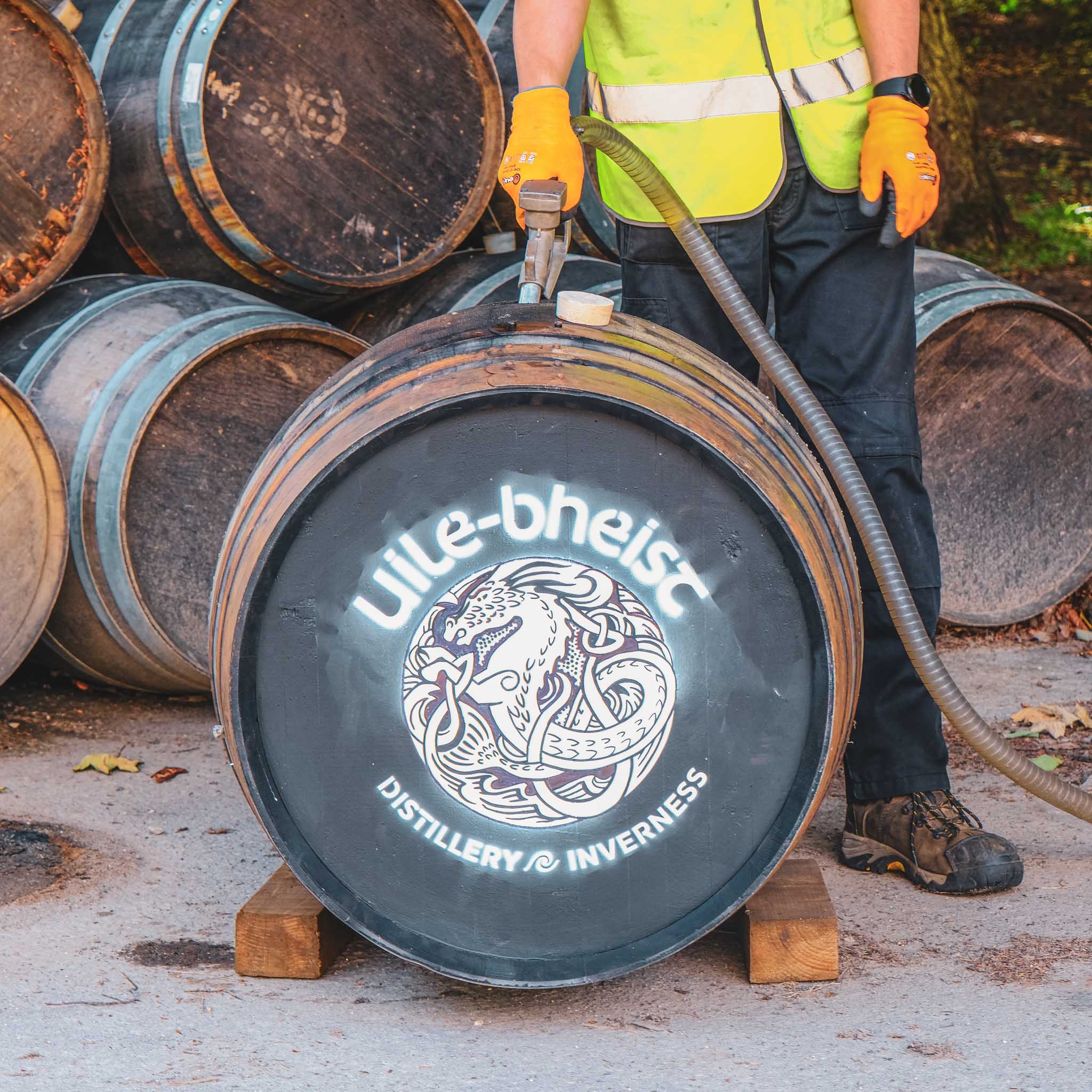 Filling a whisky cask with spirit, there is a logo of Uile-bheist